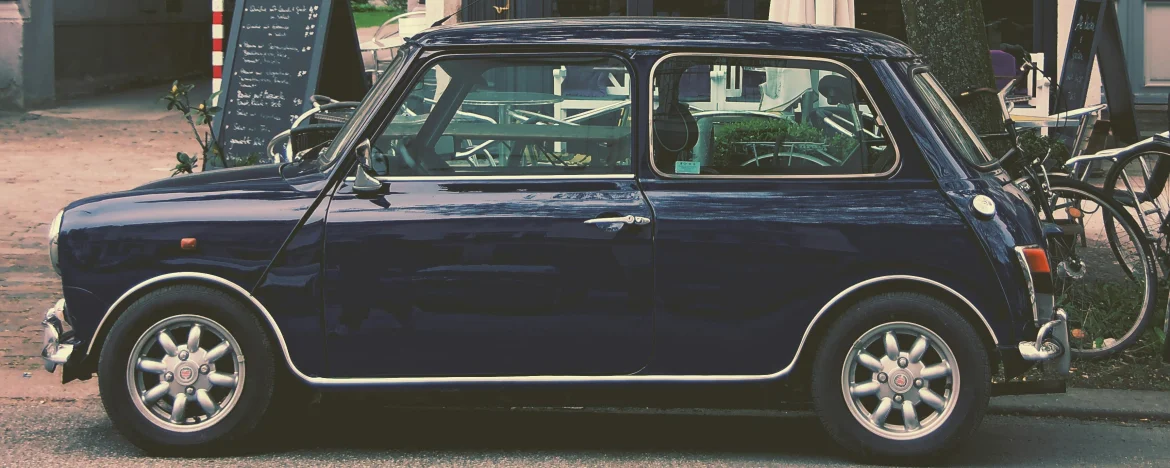 Side view of a classic Mini in navy blue