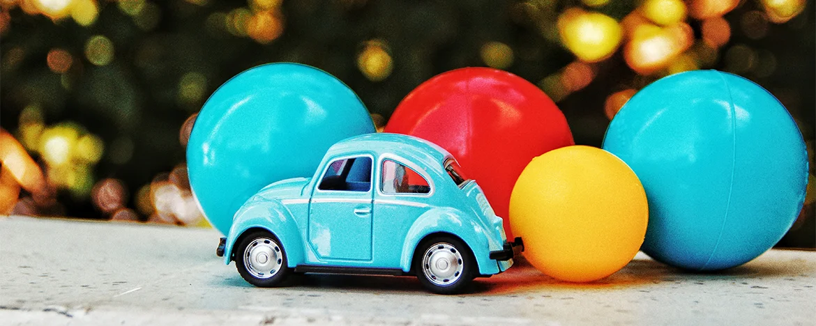 Toy car in front of colourful balls