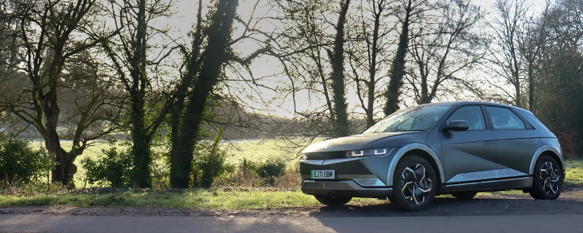 Hyundai Ioniq 5 parked under trees