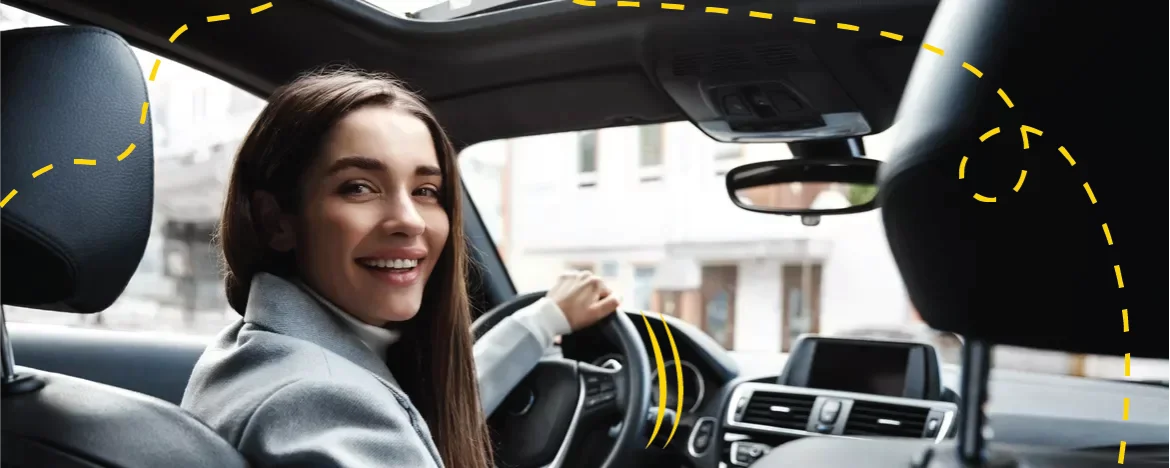 woman in car looking back smiling