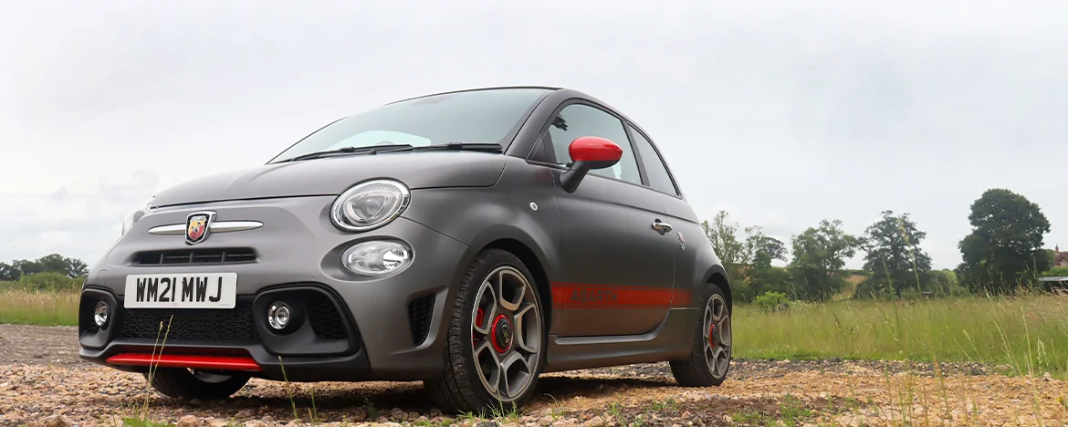 Abarth 595 parked on gravel
