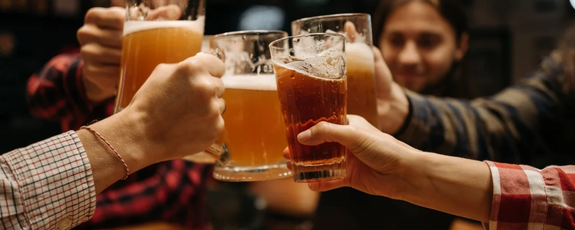 People clinking glasses of beer together