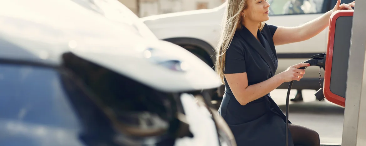 A woman at an electric charging station