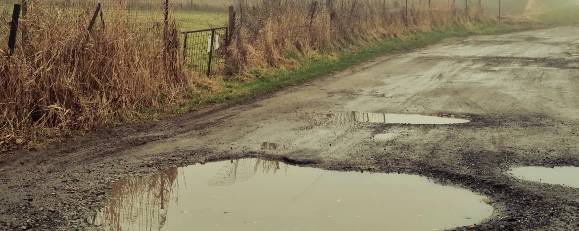 A country road with pot holes