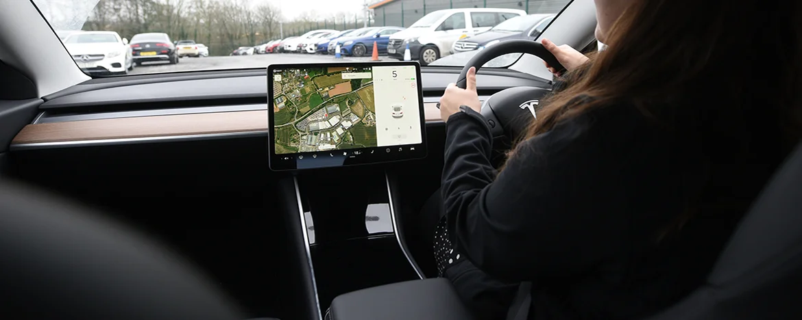 Woman driving Tesla Model 3