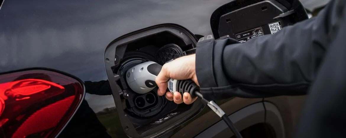 Person connecting the Mercedes-Benz EQA electric charging cable