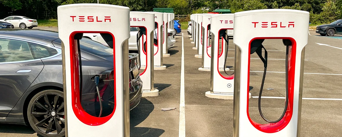 Rows of Tesla Supercharger devices at UK service station