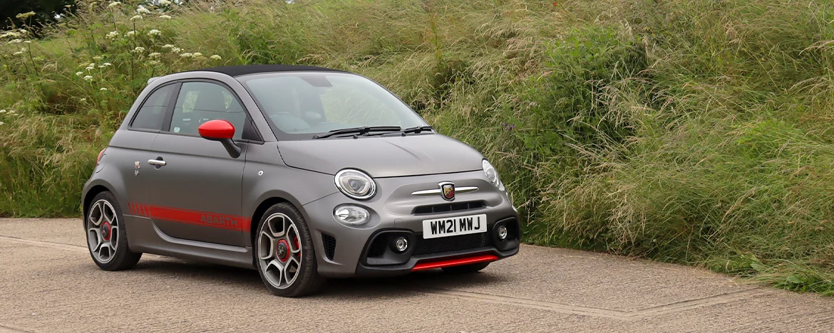 Abarth 595 parked next to grass bank