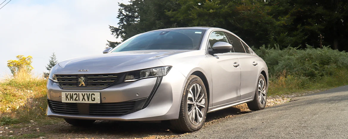 Peugeot 508 parked on hill