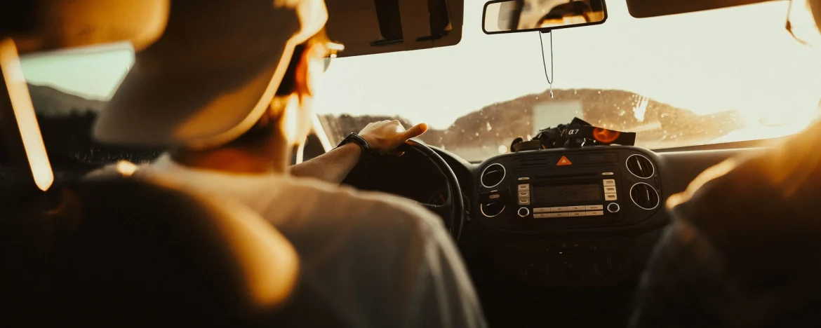 Man driving a car in the summer