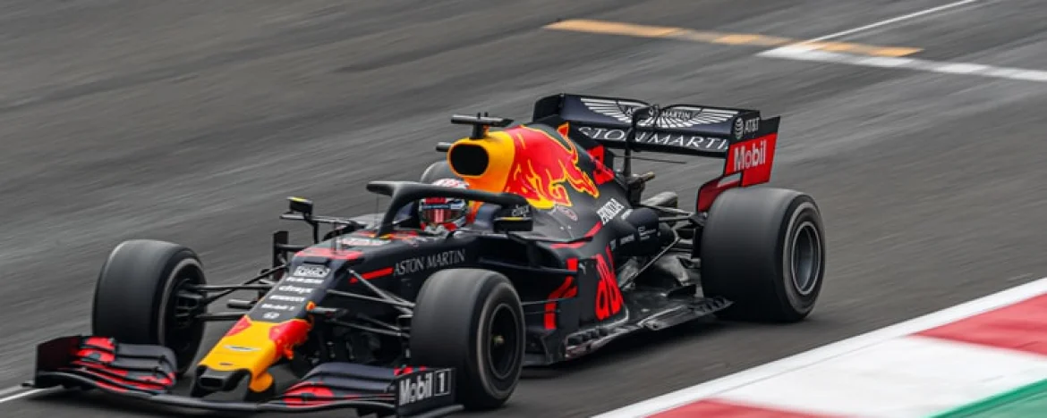 Black and orange racing car in motion