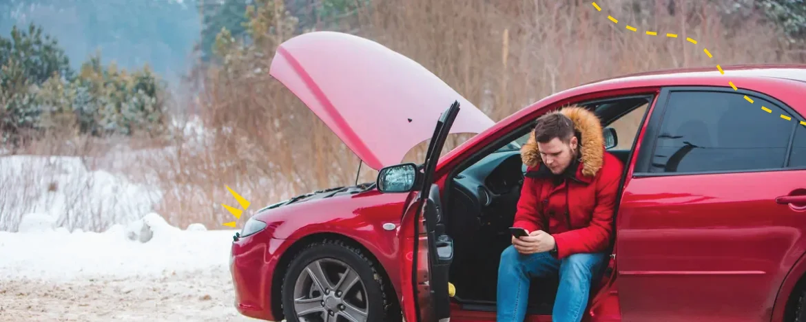 man in coat sat in car