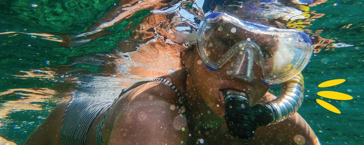 Person underwater wearing googles and a snorkel