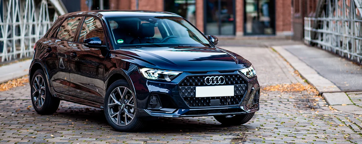 Audi A1 parked on cobbled street