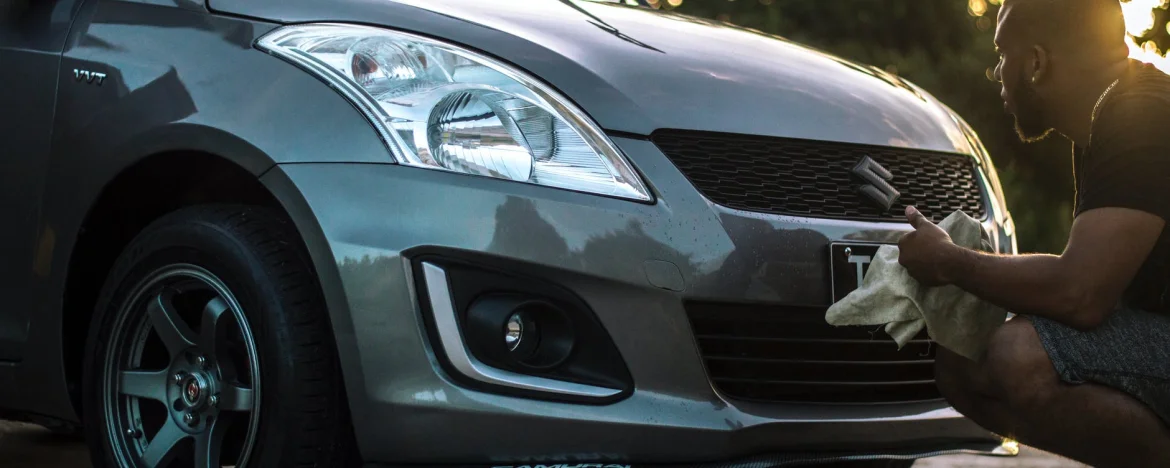 Man cleaning the front grille of his car