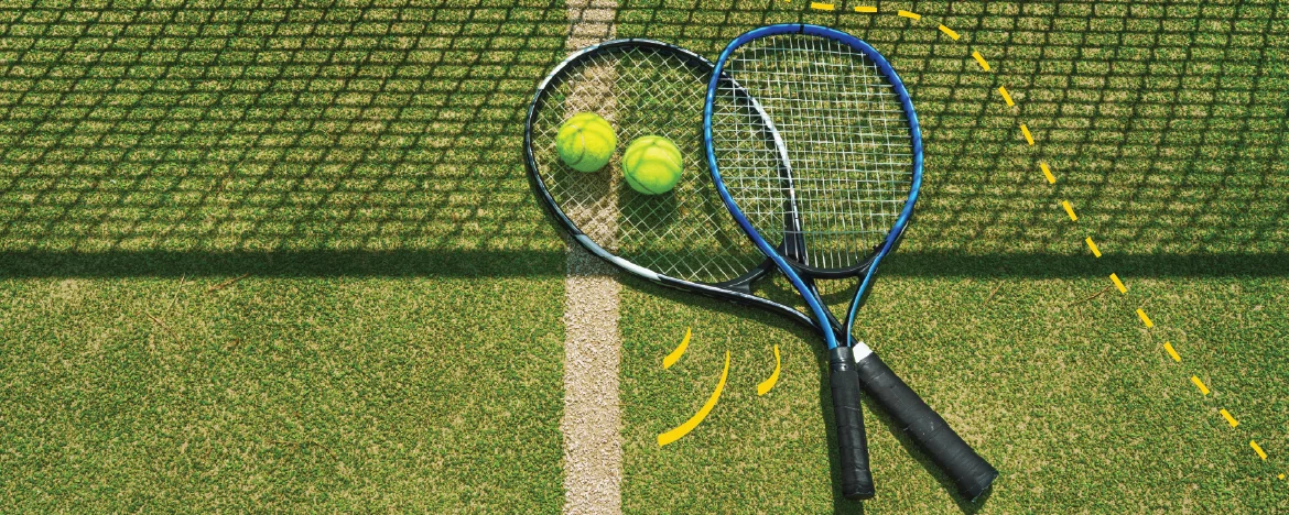 Tennis balls and racquets in shadow of the net
