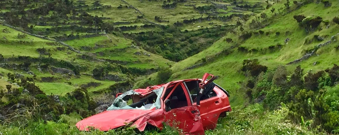 Red car crashed into the side of a hill