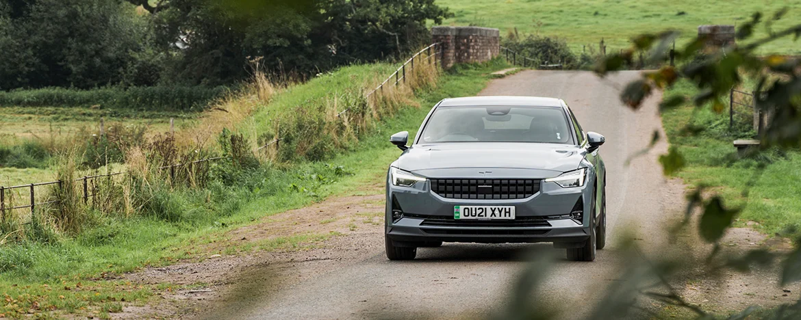 Polestar 2 driving past tree