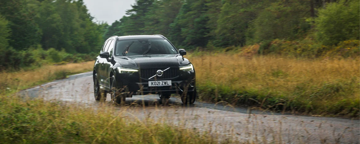Volvo XC60 driving through forest