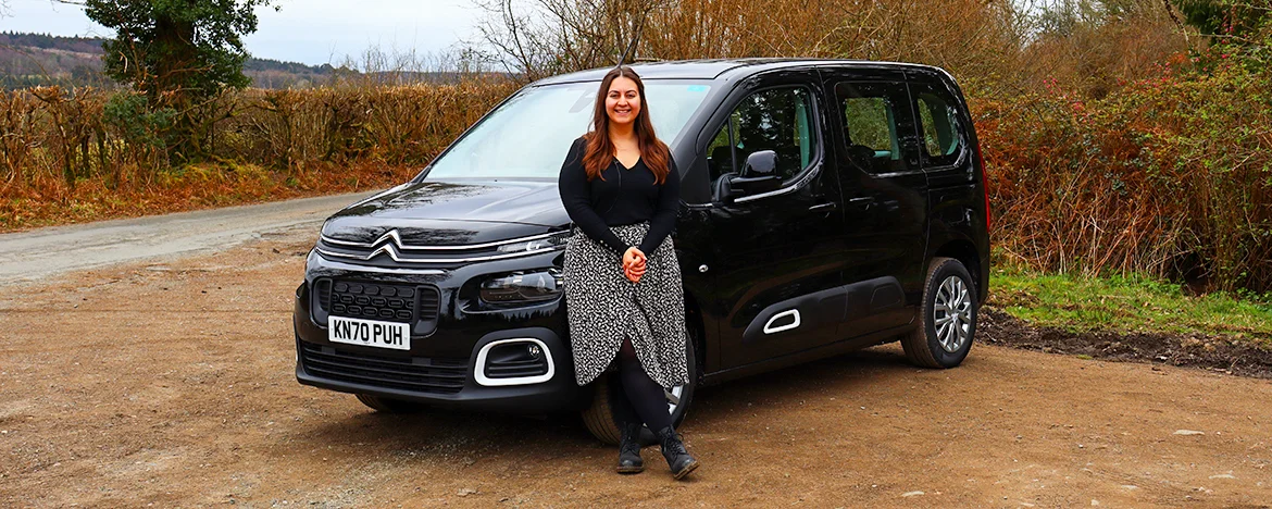 Woman stood in front of Citroen Berlingo