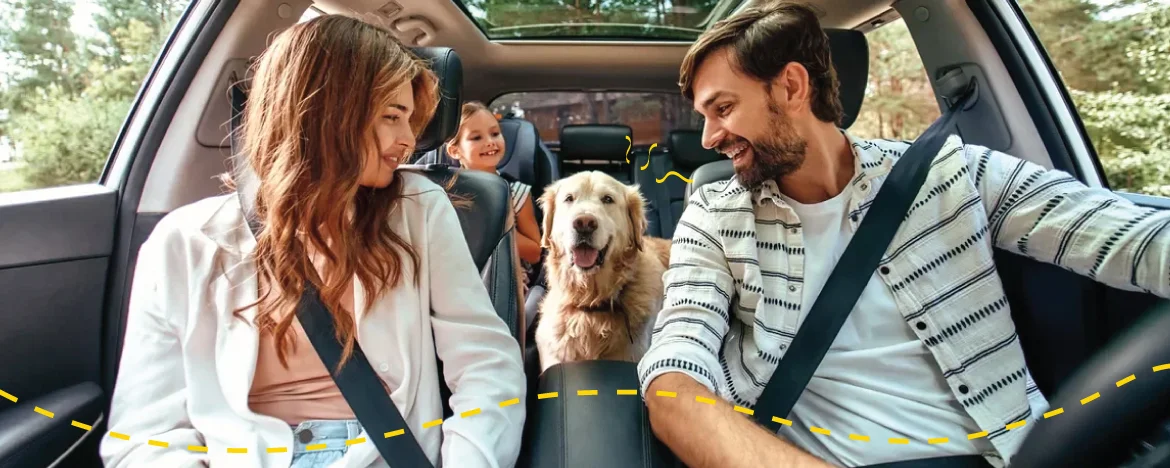 family in car with dog