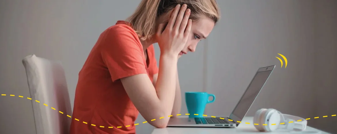 Woman looking at her laptop worriedly 