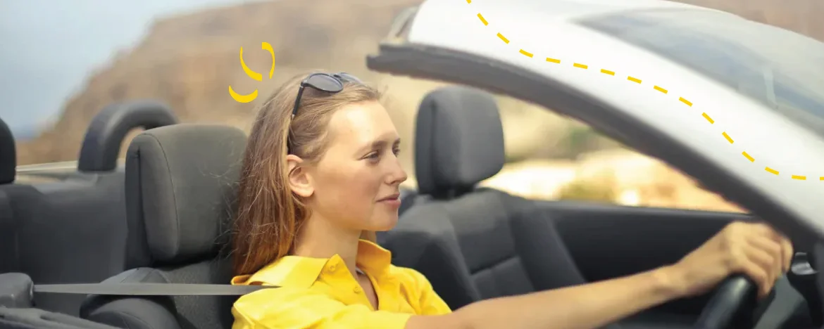 woman driving with sunglasses on head