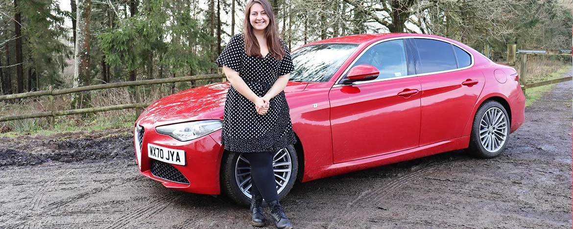 Woman stood next to Alfa Romeo Giulia