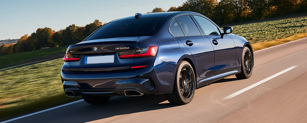 BMW 3 Series Saloon driving along road