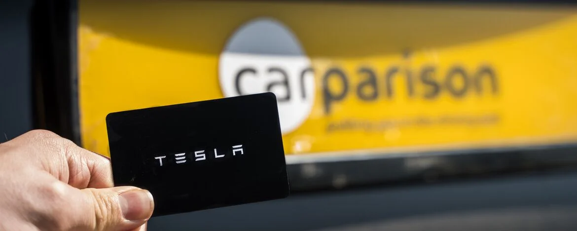Tesla Model Y keycard in front of Carparison number plate