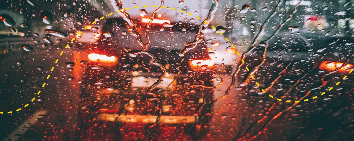View through wet windshield of car braking