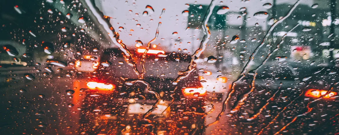 View through wet windshield of car braking