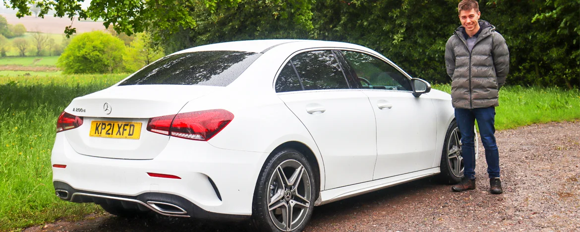 Man stood next to A-Class Saloon