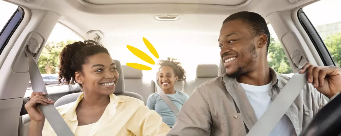 Family in a car putting seatbelts on