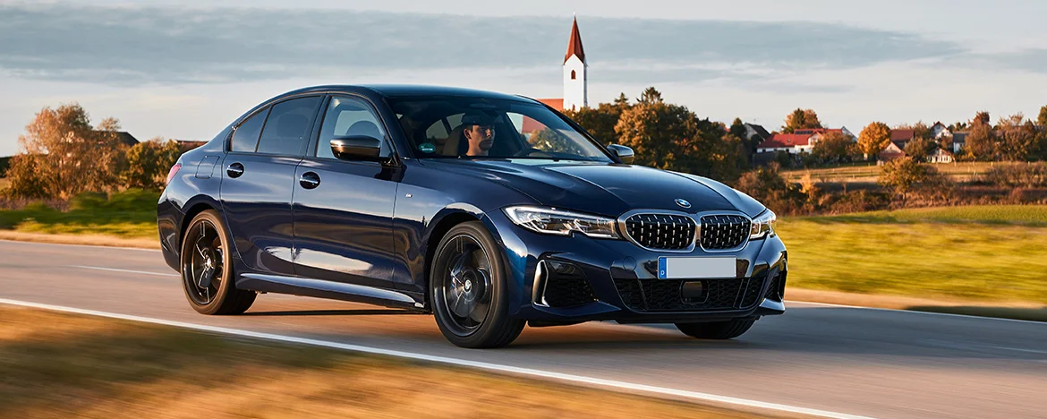 BMW 3 Series driving on the road