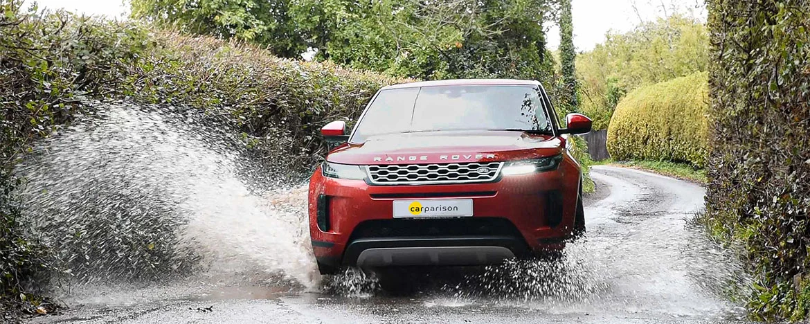 Range Rover splashing through puddle