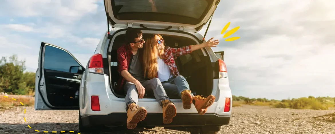 two people sat in boot of car
