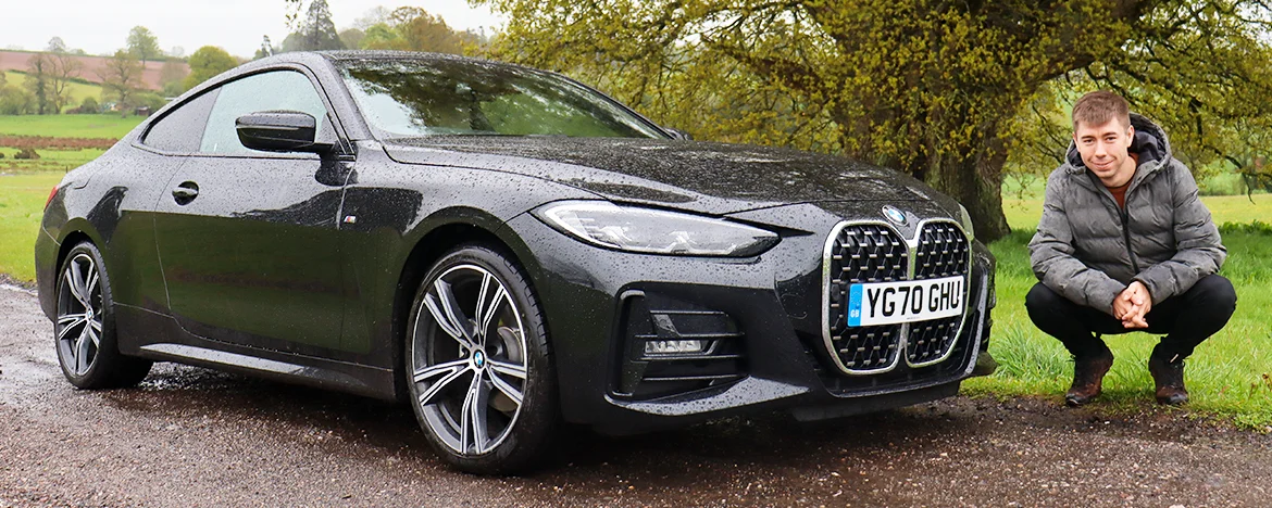 Man stood next to bmw 4 series 