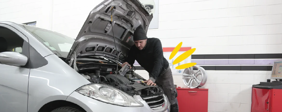 person doing maintenance on car