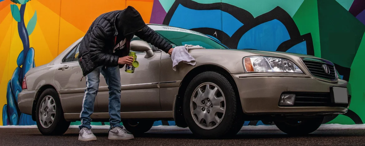 Man cleaning car the the street 