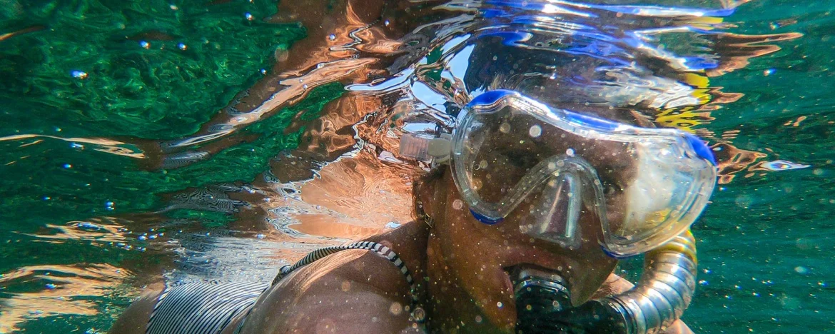 Person underwater wearing googles and a snorkel