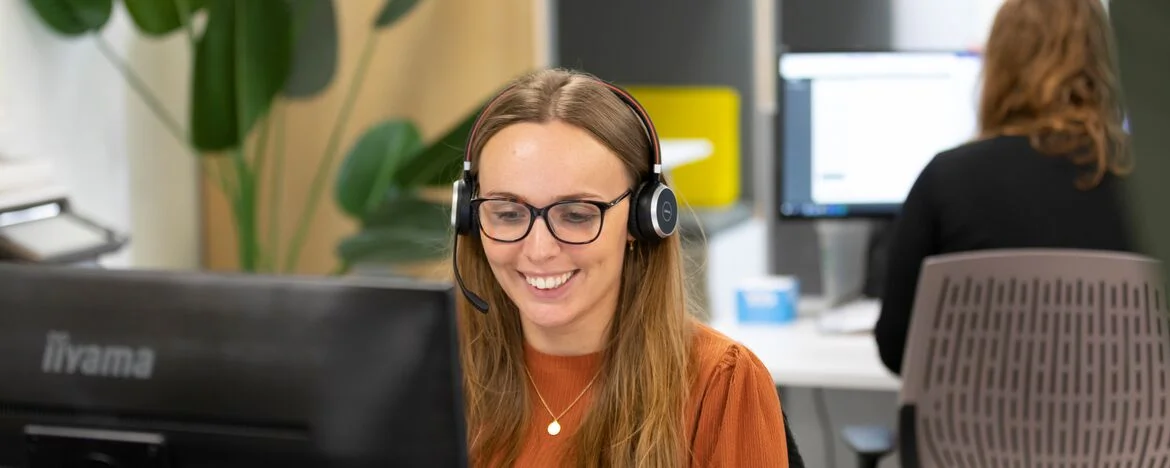 Carparison office with smiling phone agent