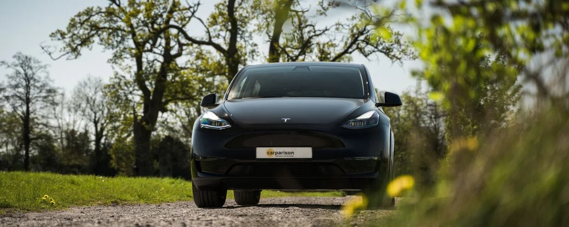 Tesla Model Y parked in country field