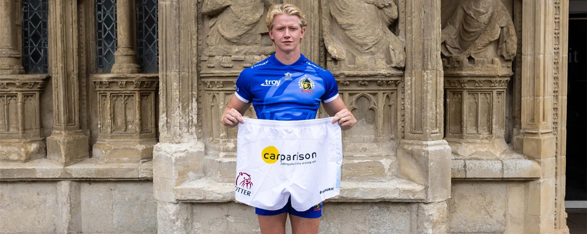 Exeter Chiefs' Josh Hodge holding Carparison-branded shorts