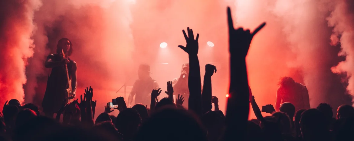 A large crowd watching a band on stage