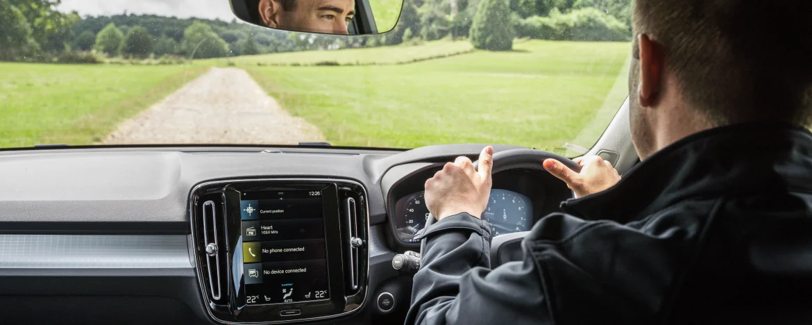 Man driving Volvo XC60 across Devon country road