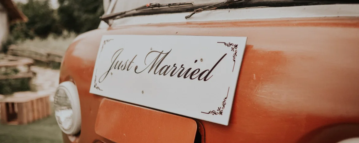 Just married sign on a car trunk