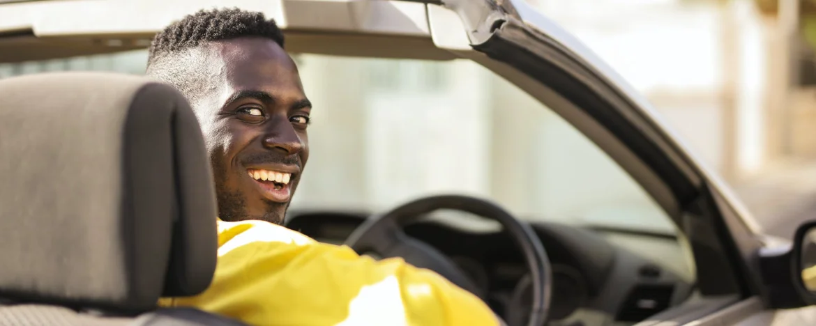 Happy person driving a convertible car