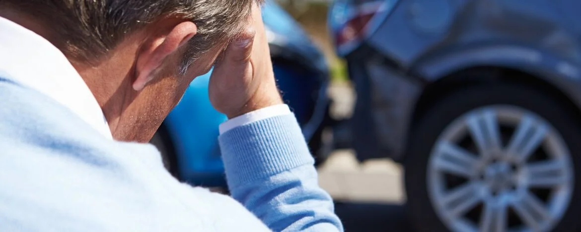 Driver with head in hands after road collision