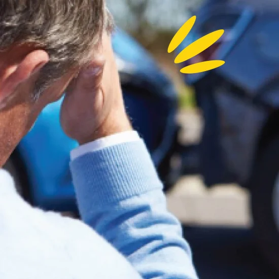 Driver with head in hands after road collision